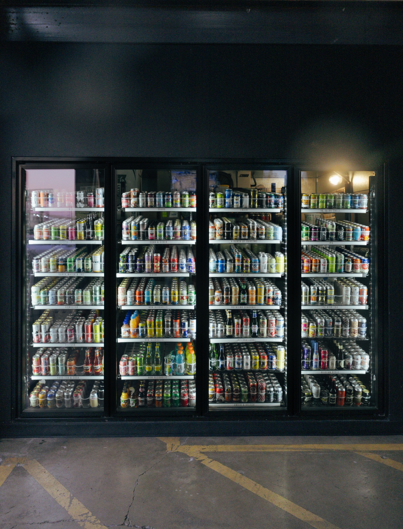 Guest reaching into the 250+ bottle cooler wall